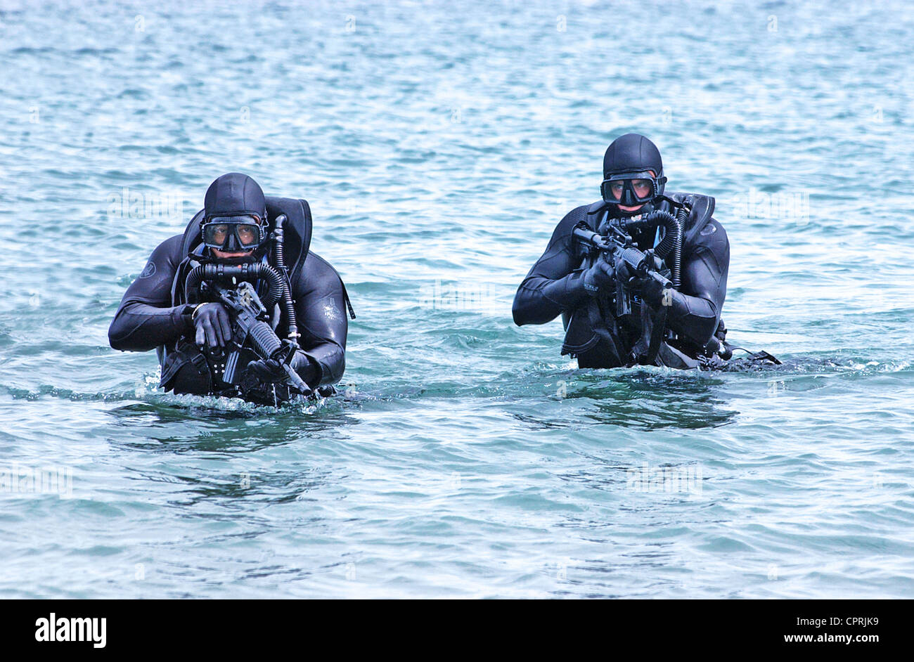 US Navy SEALs practice beach landings during combat training Stock