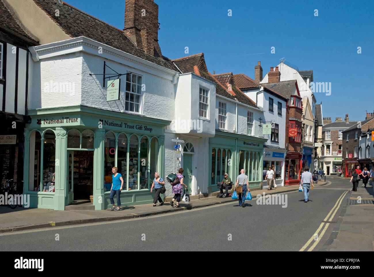 People tourists visitors Shops Stores in spring York City Town Centre Goodramgate North Yorkshire England UK United Kingdom GB Great Britain Stock Photo
