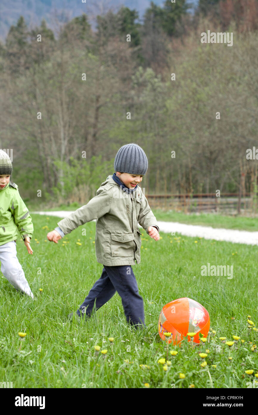 Boys playing with ball Stock Photo - Alamy