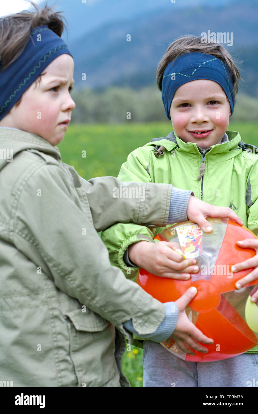 Boys playing with ball Stock Photo - Alamy