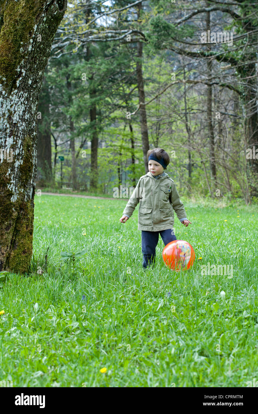Boy playing with ball outdoor Stock Photo - Alamy