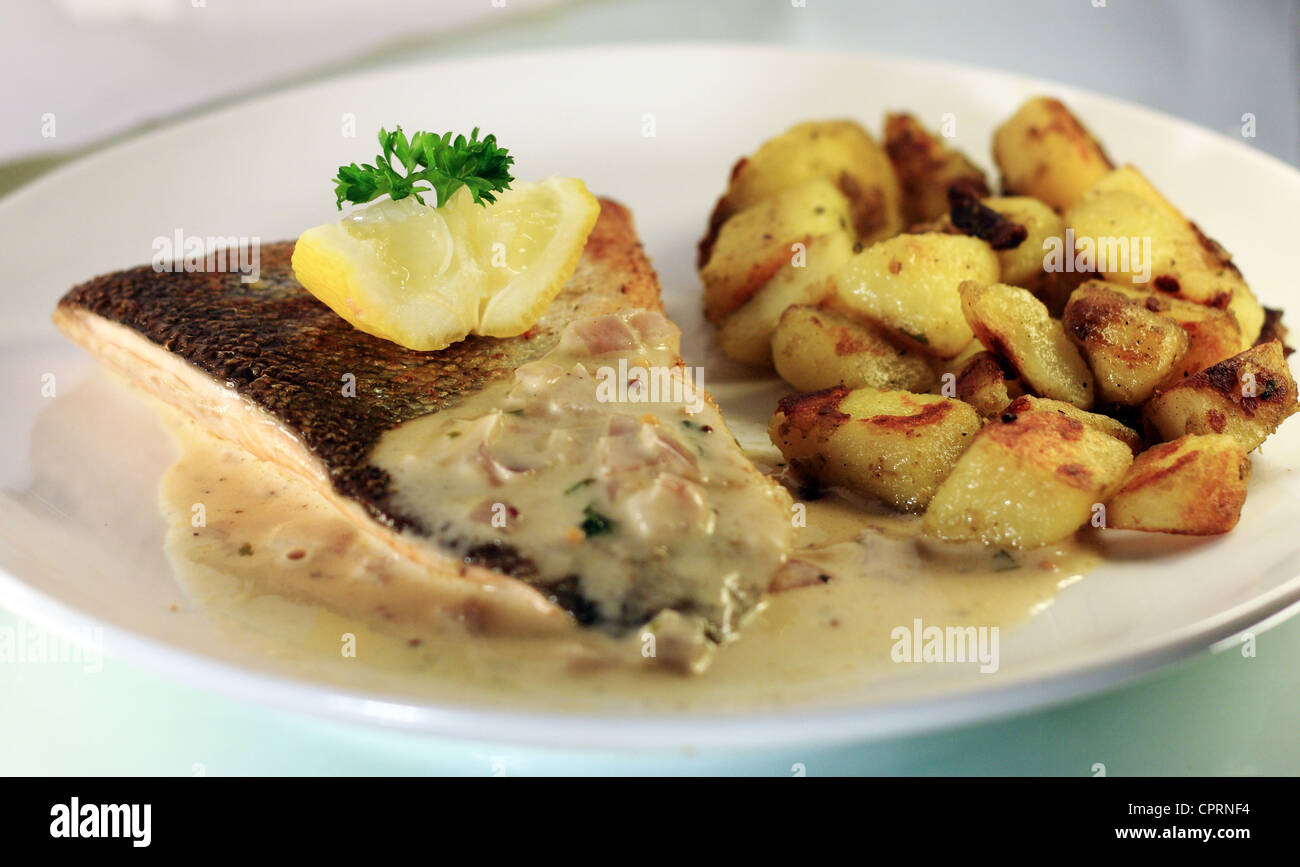 A fine dining fish course of Lemon Sole with fricaseed potatoes ...