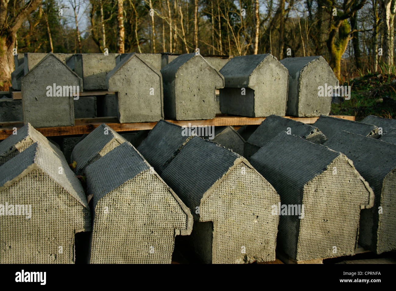 Molded cement shapes drying, to be used as capping stones on a folly castle. Stock Photo