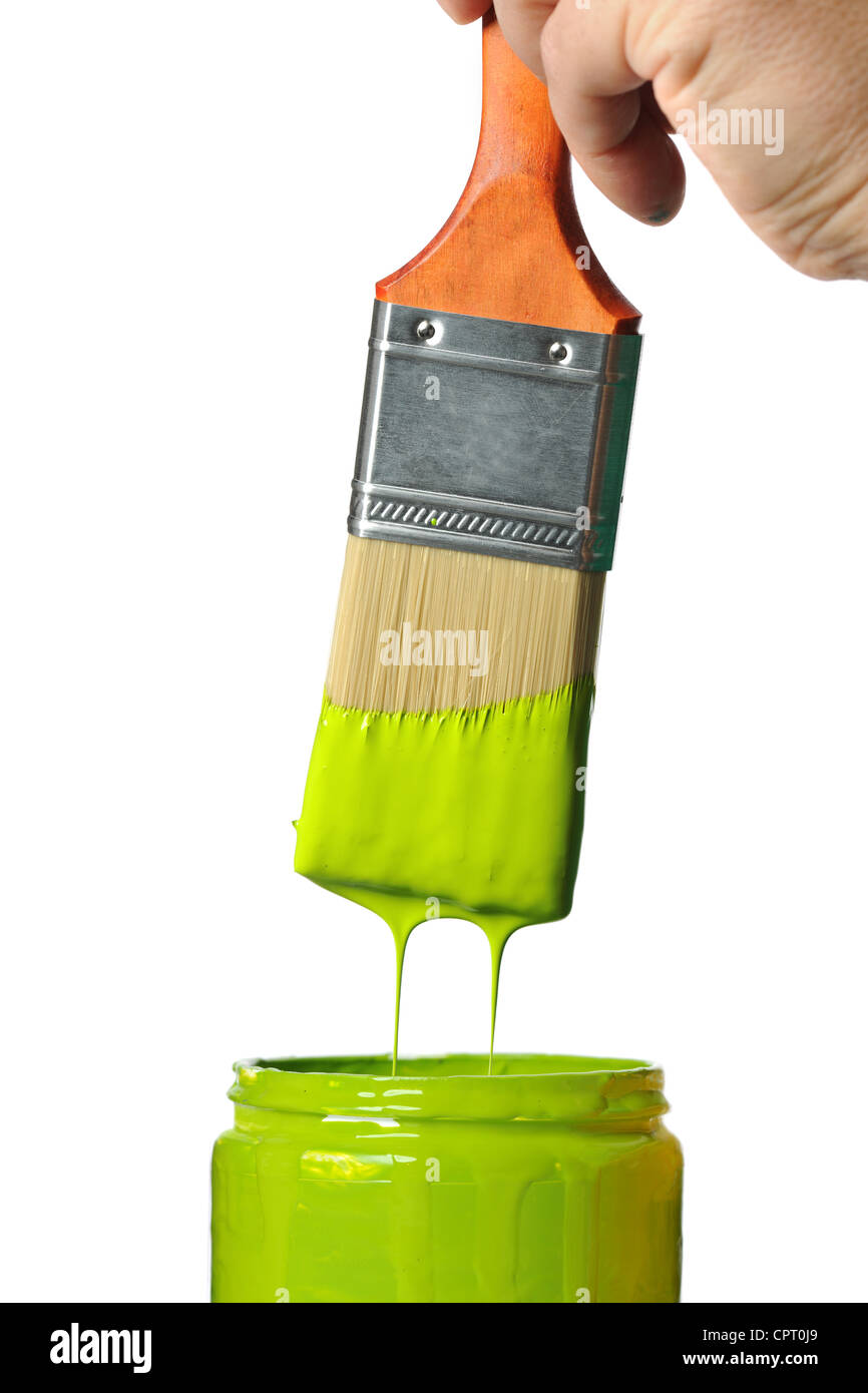 Paintbrush with green paint dripping into container isolated over white background Stock Photo