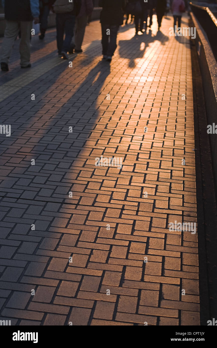 Shadows of people walking on a city street at the dusk Stock Photo - Alamy