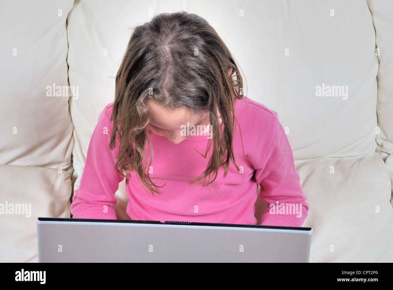 Girl sitting on the sofa and using laptop Stock Photo - Alamy