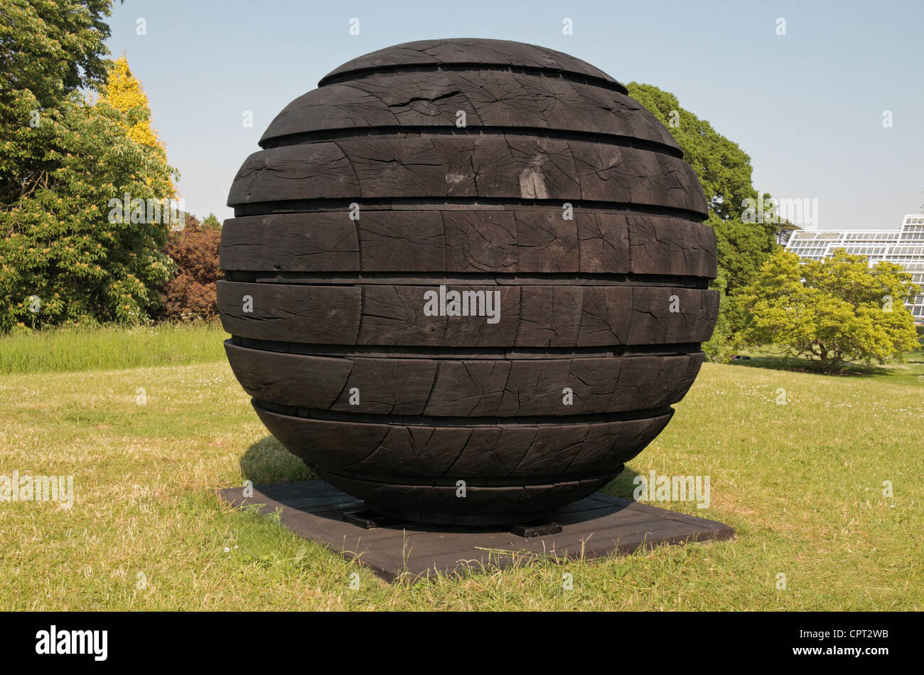 The 'Black Sphere' sculpture by David Nash, part of David Nash at Kew Gardens, Royal Botanic Gardens, Kew, Surrey. May 2012 Stock Photo