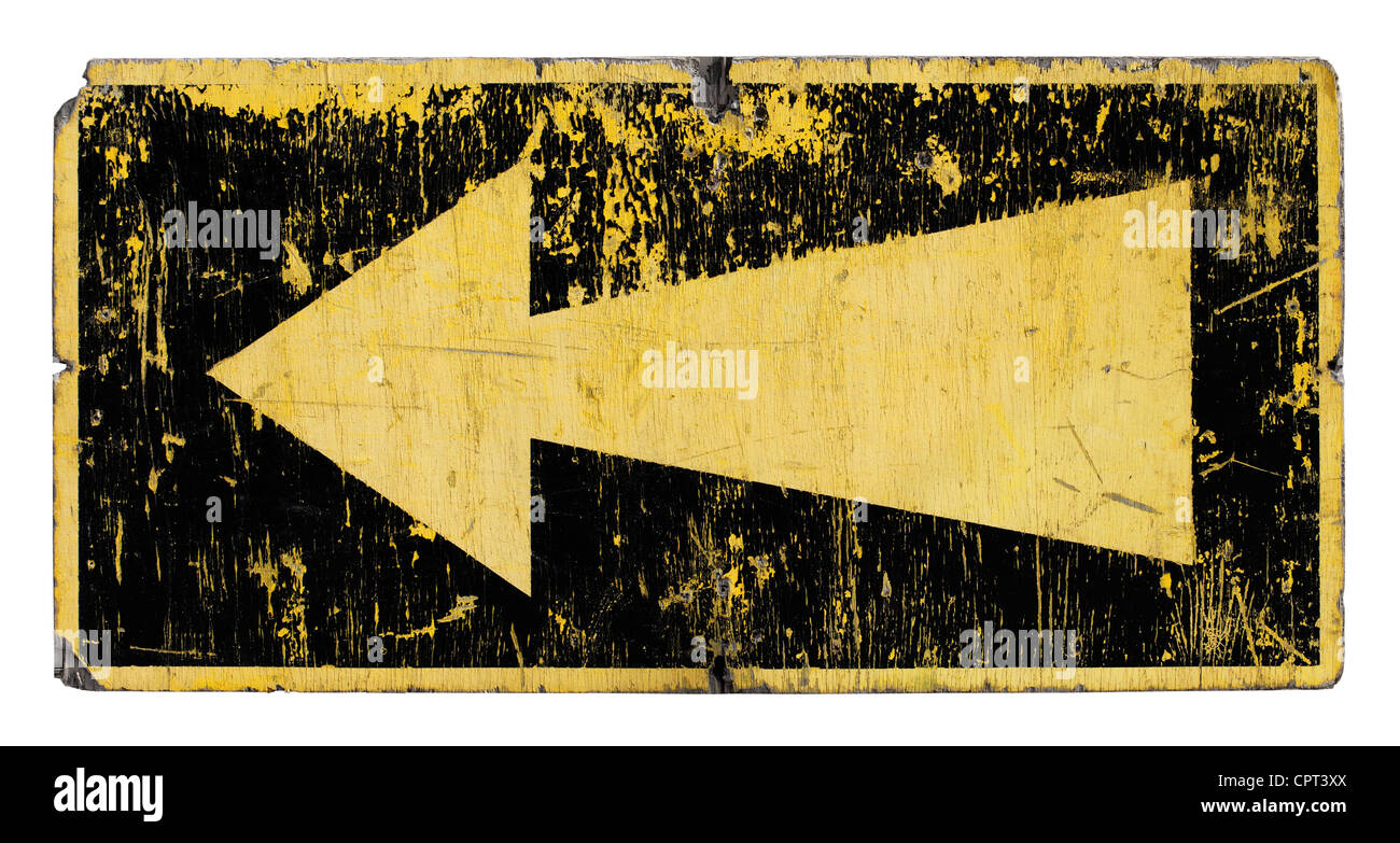 Old, worn and weathered sign with a yellow arrow. Stock Photo