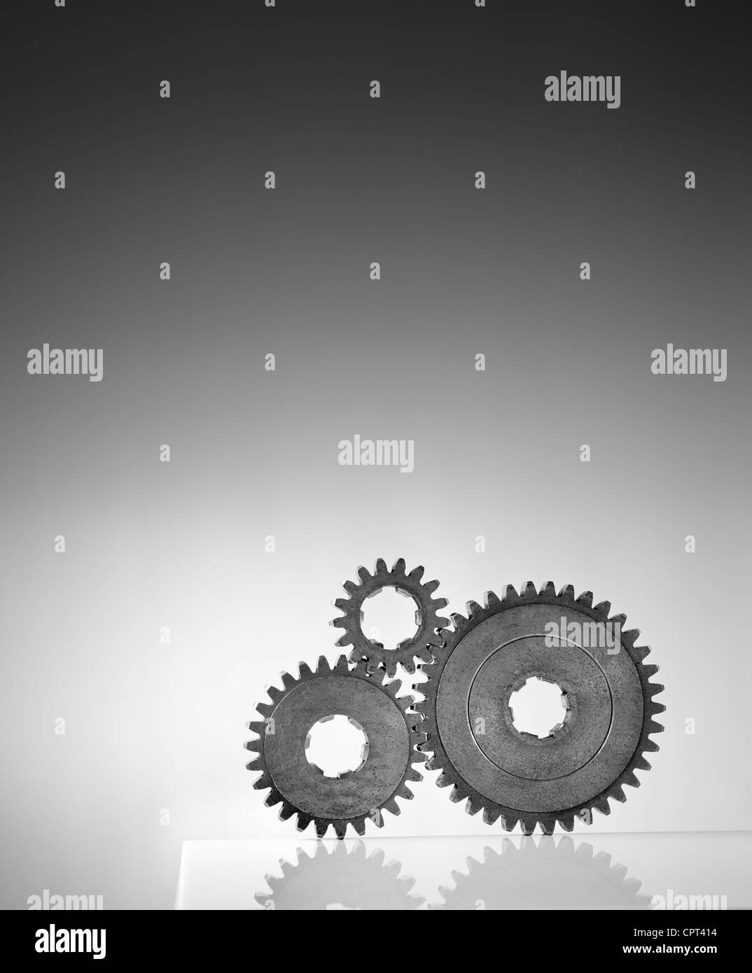 Black and white photograph of three old cog gear wheels. Stock Photo