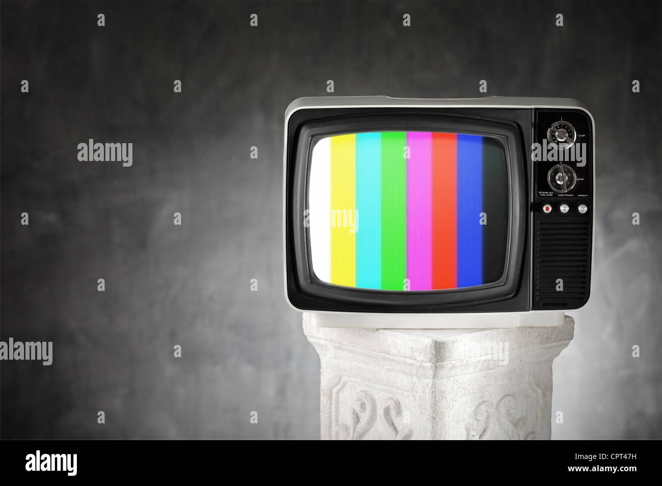 Old television with color bars on a plaster column. Stock Photo