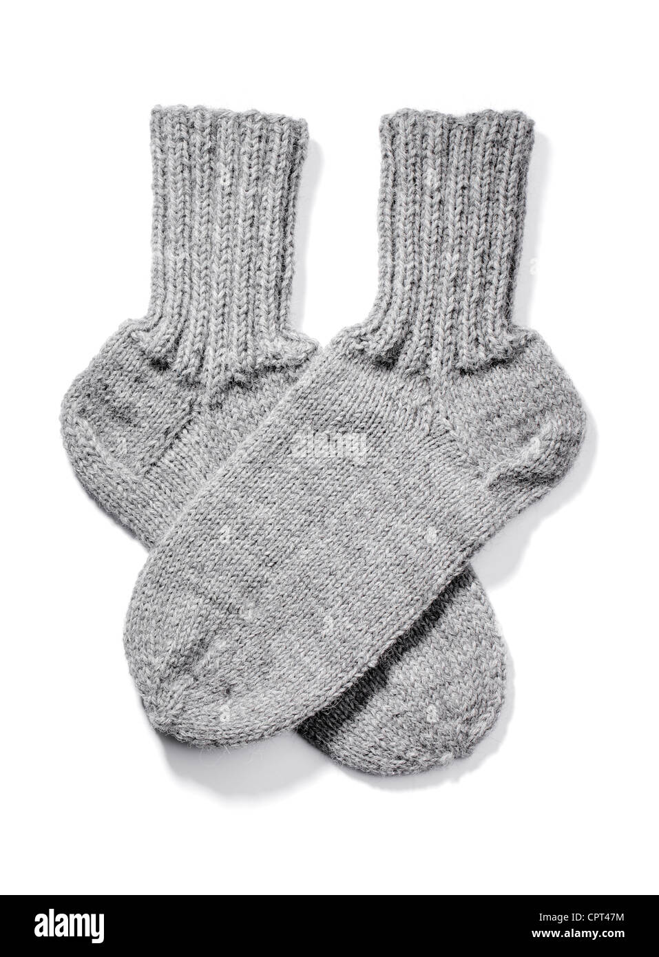 Hand-knitted warm wool socks isolated on white with natural shadows. Stock Photo