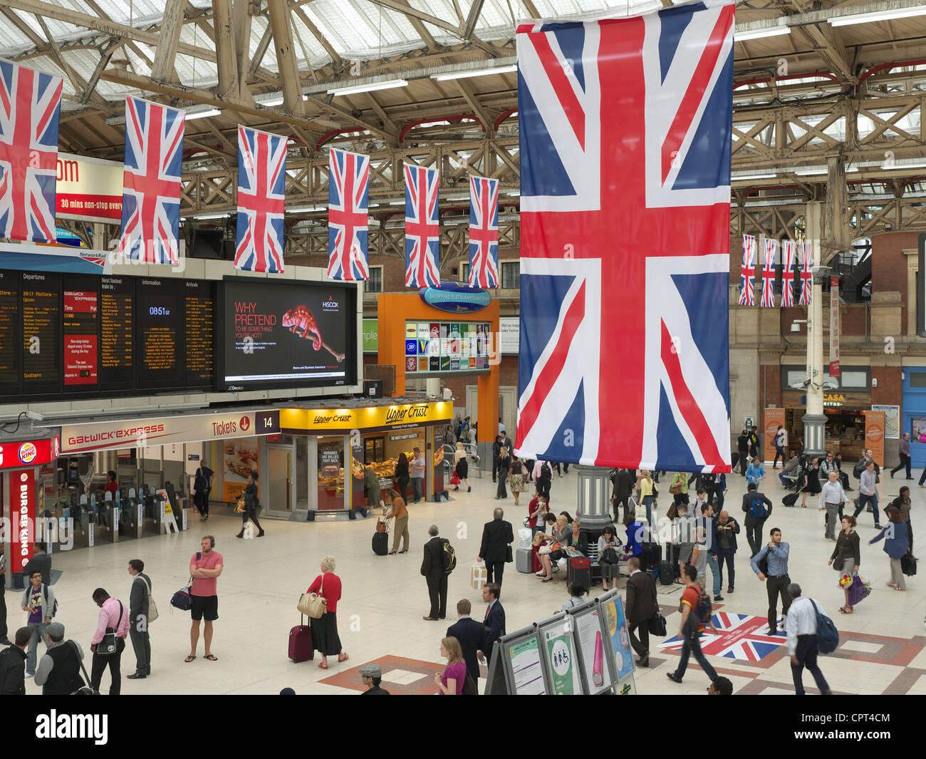 view-of-union-jack-flags-hanging-above-the-concourse-of-victoria-station-CPT4CM.jpg