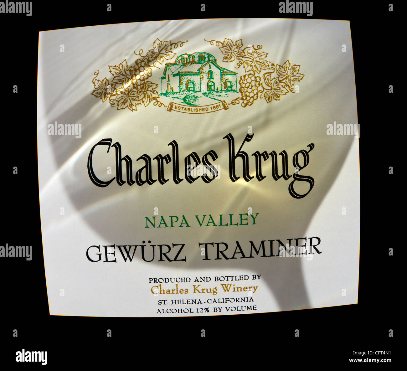 Charles Krug Gewürz Traminer bottle label Napa Valley, with shadow of wine swirling in tasting glass Stock Photo