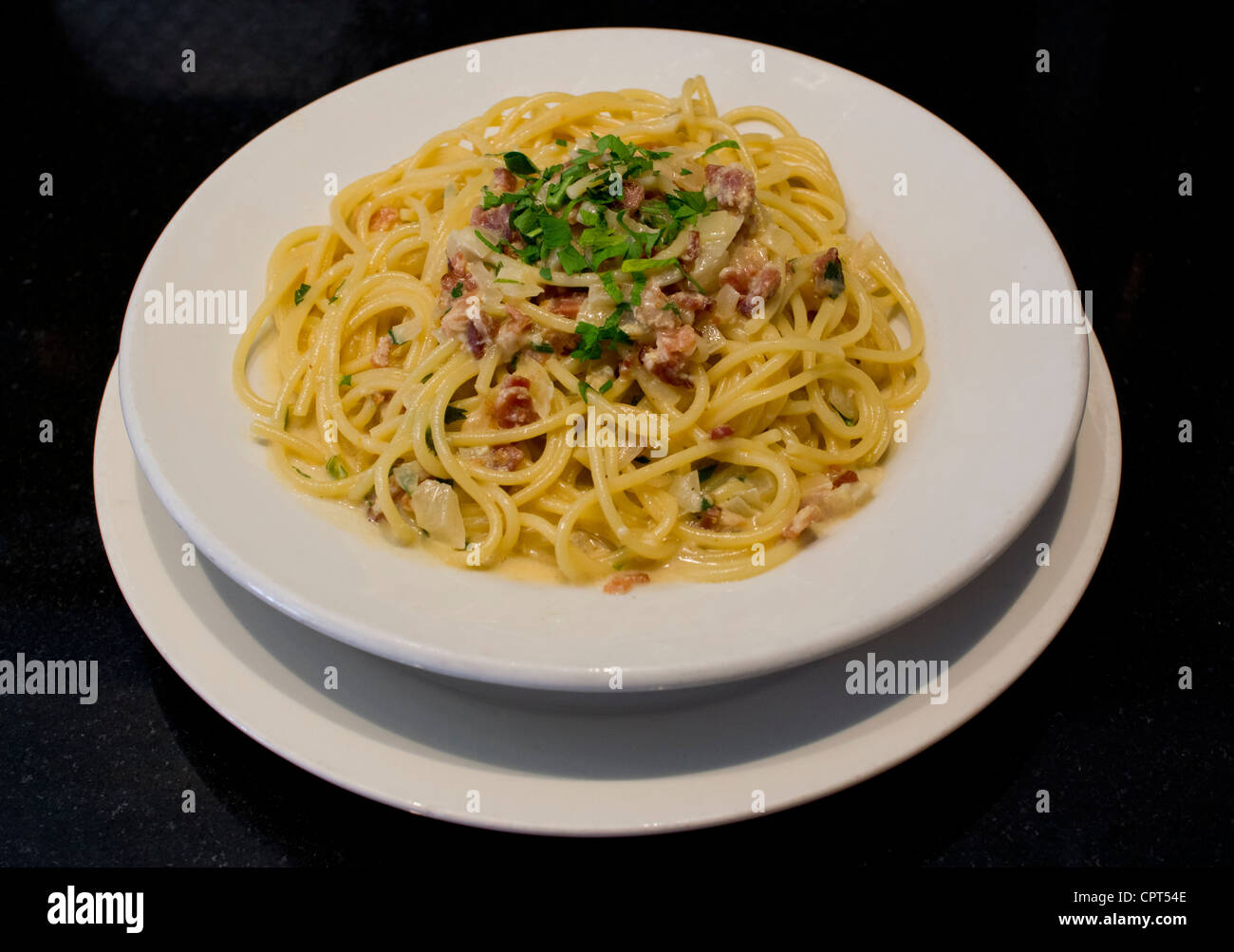 A serving of Spaghetti alla Carbonara, a pasta dish Stock Photo