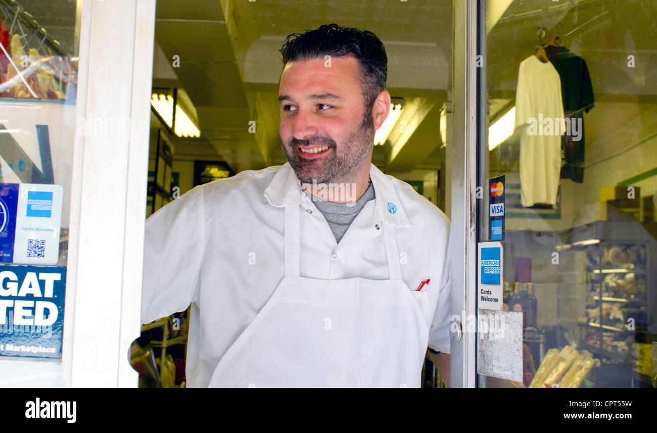 Man working in a famous Italian deli and cheese shop on Grand Street in