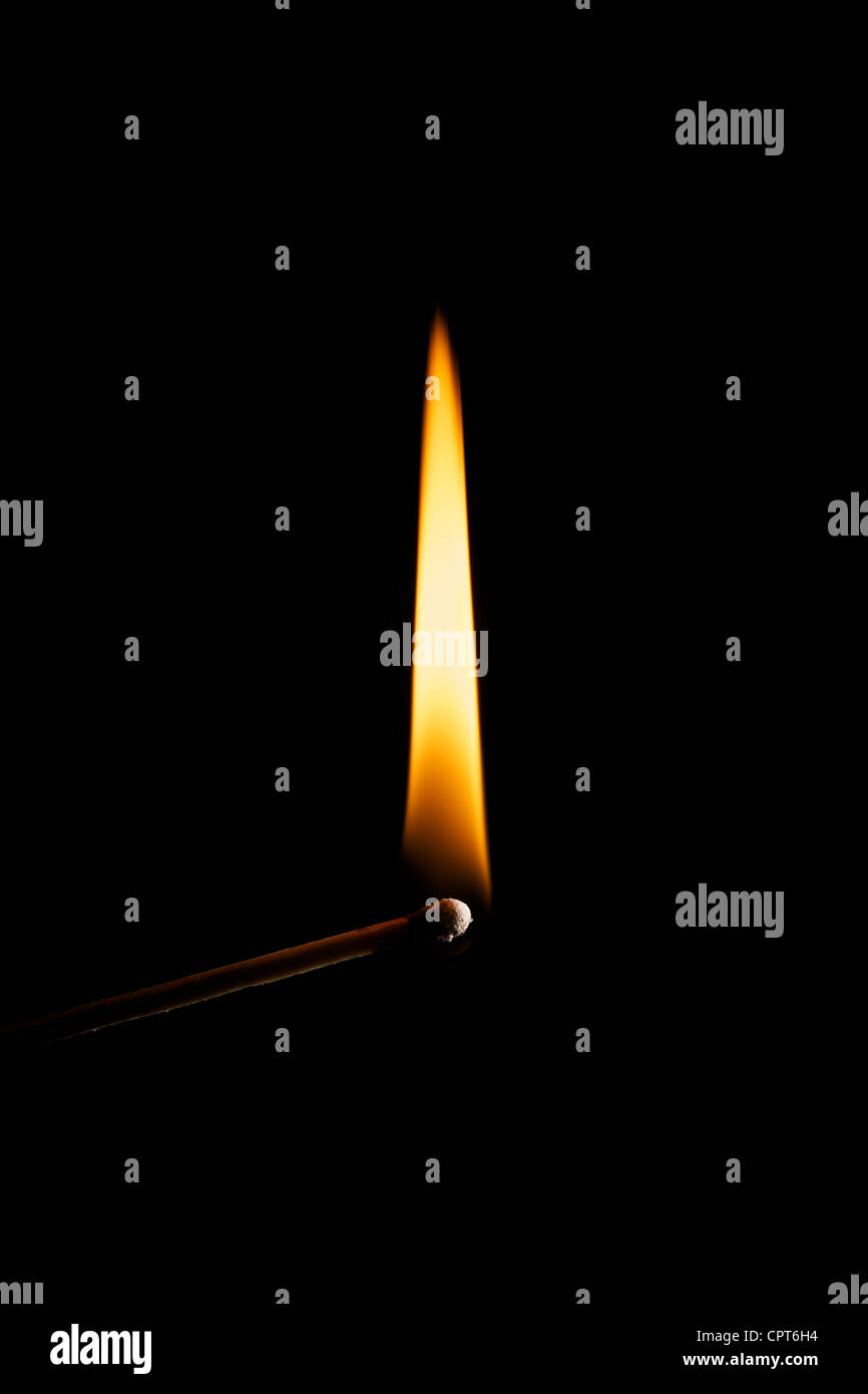Burning match over a black background Stock Photo - Alamy