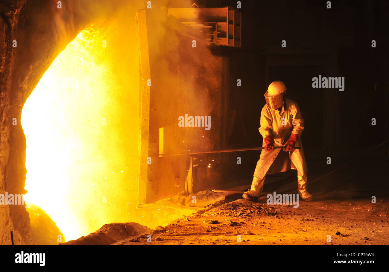 worker takes a sample at steel company Stock Photo