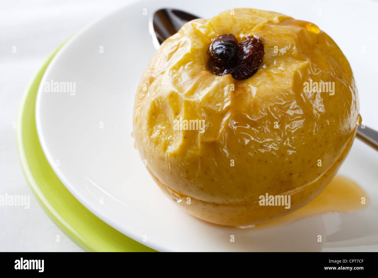 Apple, stuffed with raisins and baked with honey syrup. Stock Photo