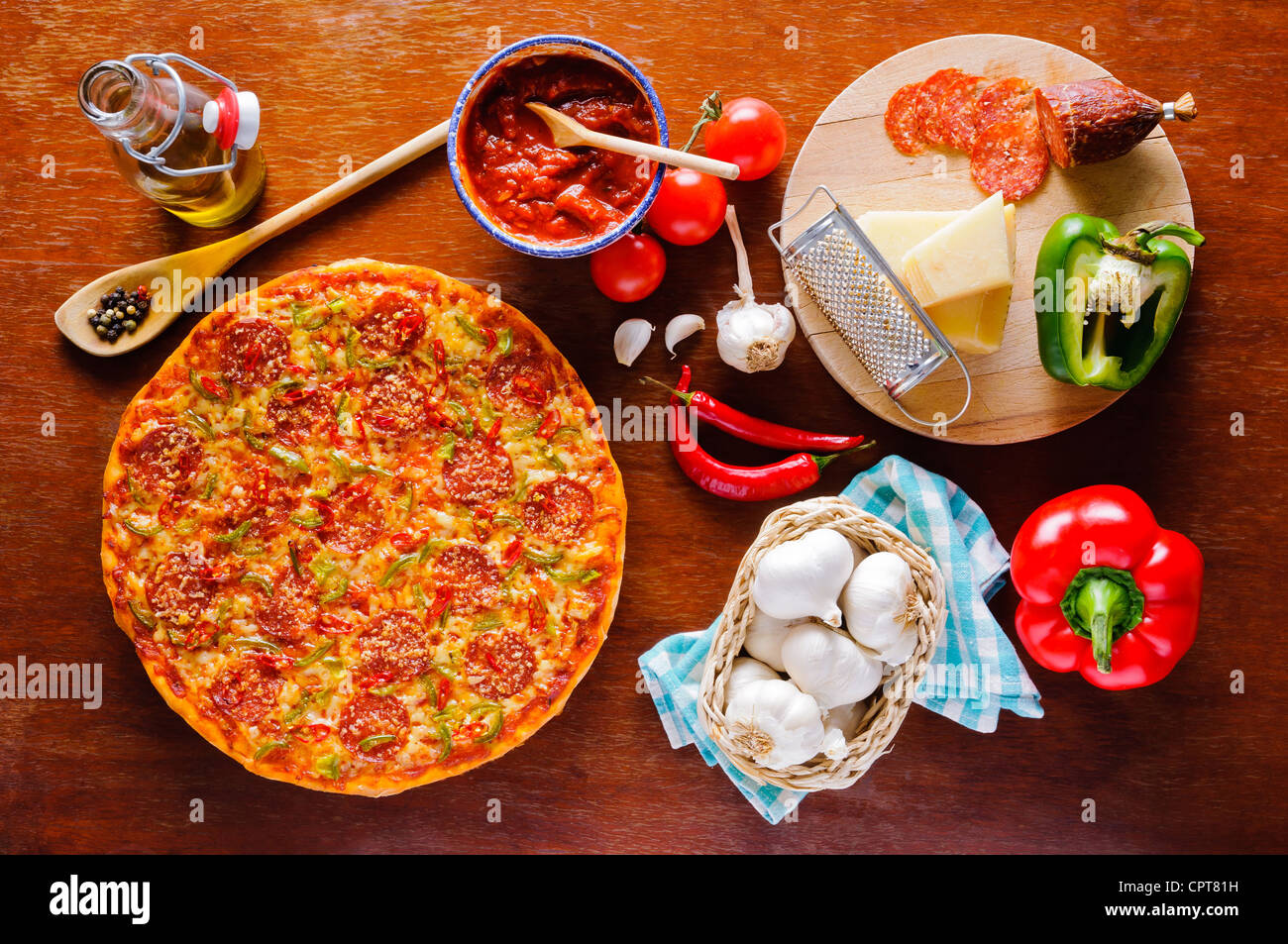 Traditional italian homemade pepperoni pizza and ingredients Stock Photo