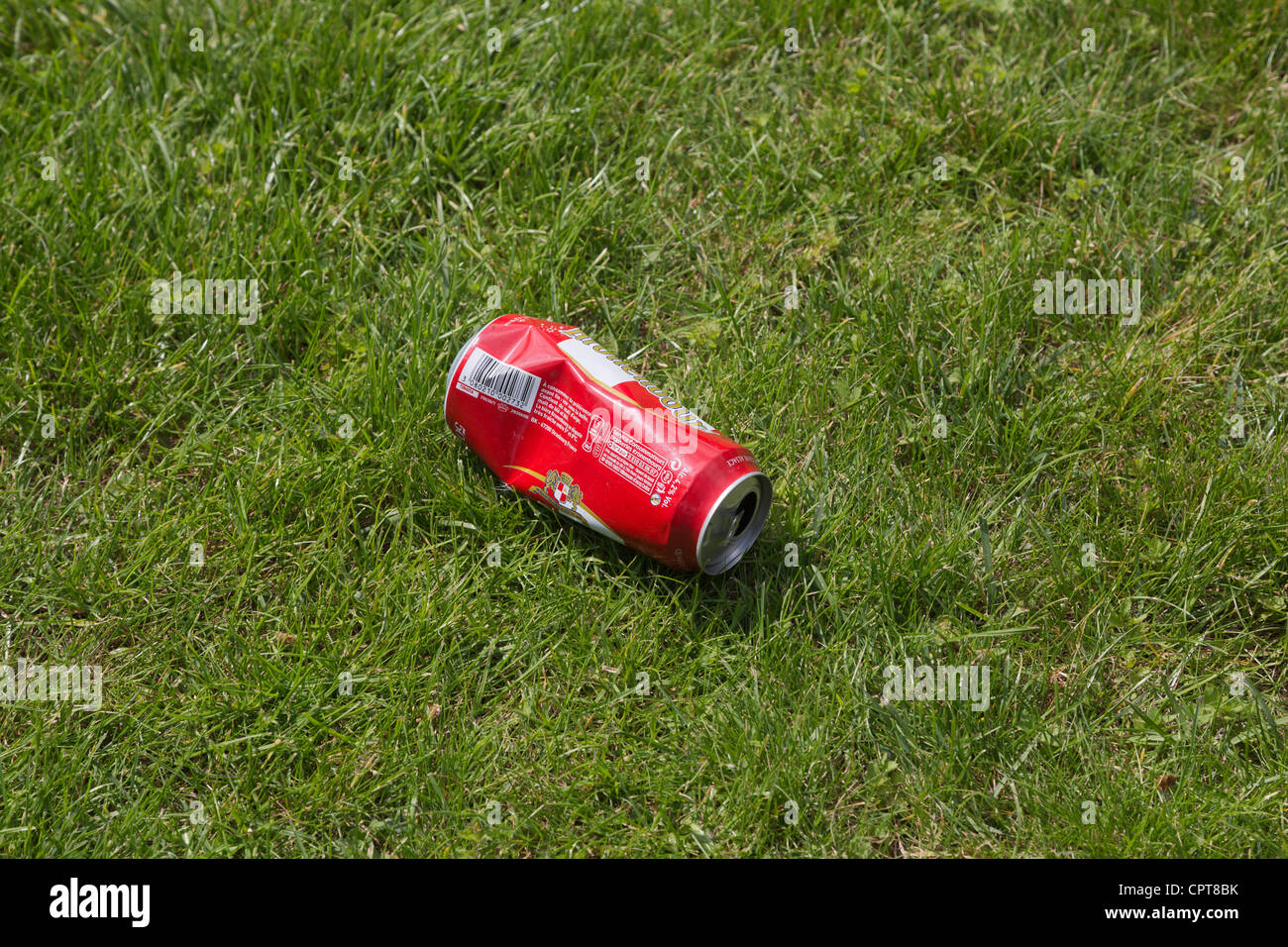 An empty beer can thrown on the grass Stock Photo