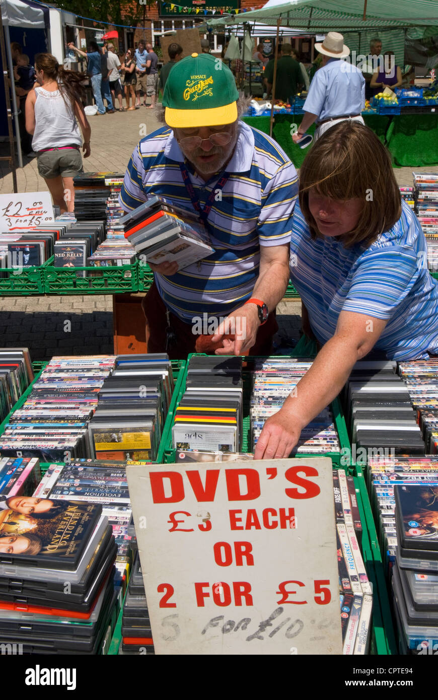 People perusing DVD stall at the weekly outdoor market, Petersfield, Hampshire, UK. Stock Photo