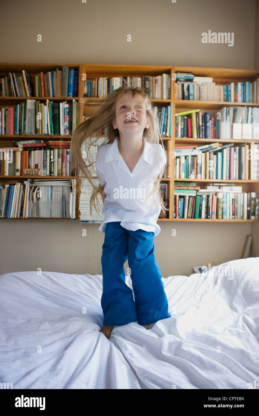 Girl jumping on bed Stock Photo Alamy