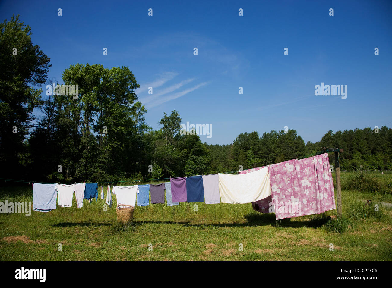 Clothes hanging on washing line in field Stock Photo