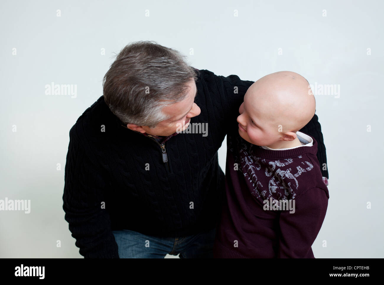 Father son with Down's Syndrome looking at each other Stock Photo