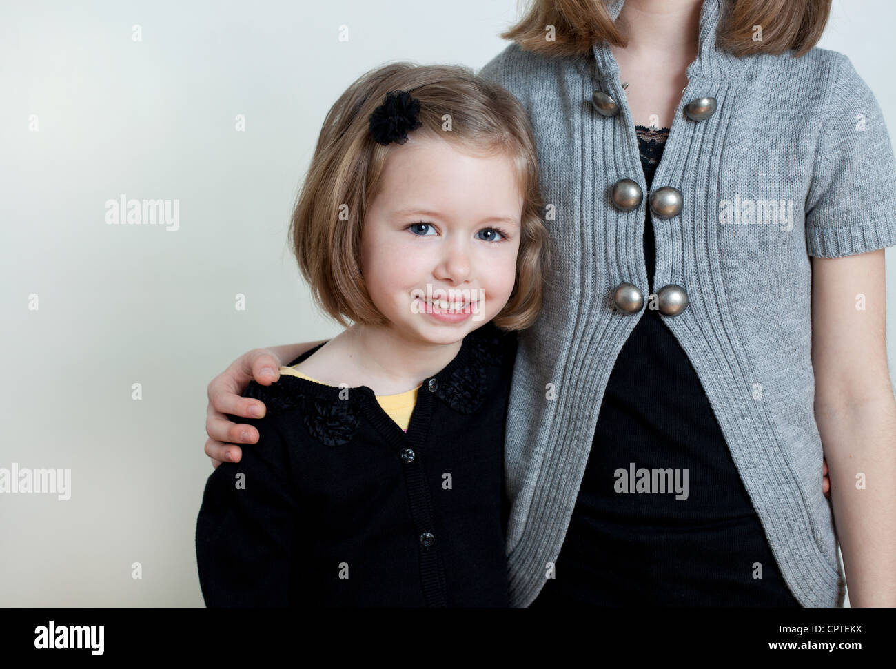 Portrait of two sisters, studio shot Stock Photo