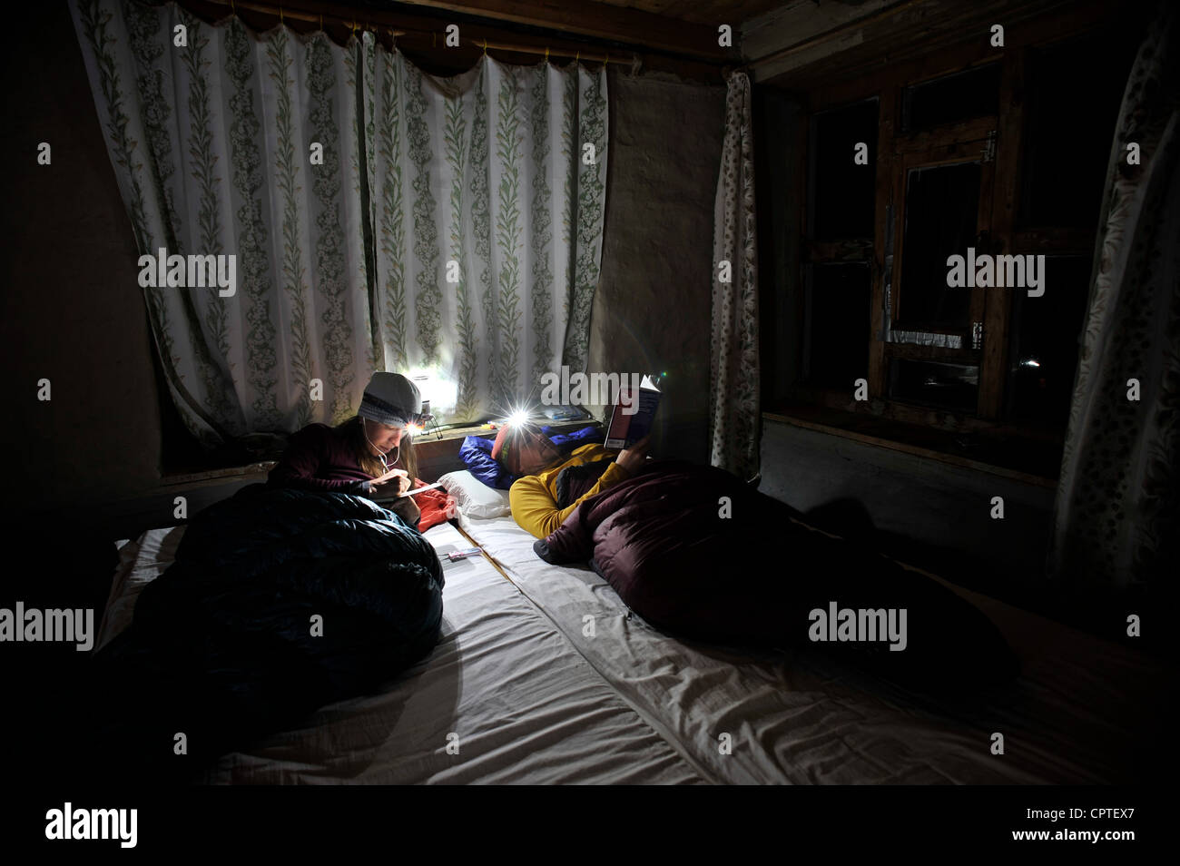 Couple in room in sleeping bags, Yak Kharka, Nepal Stock Photo