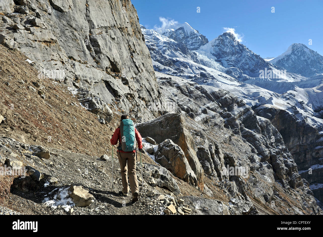 Female trekker following trail, Thorung La, Nepal Stock Photo