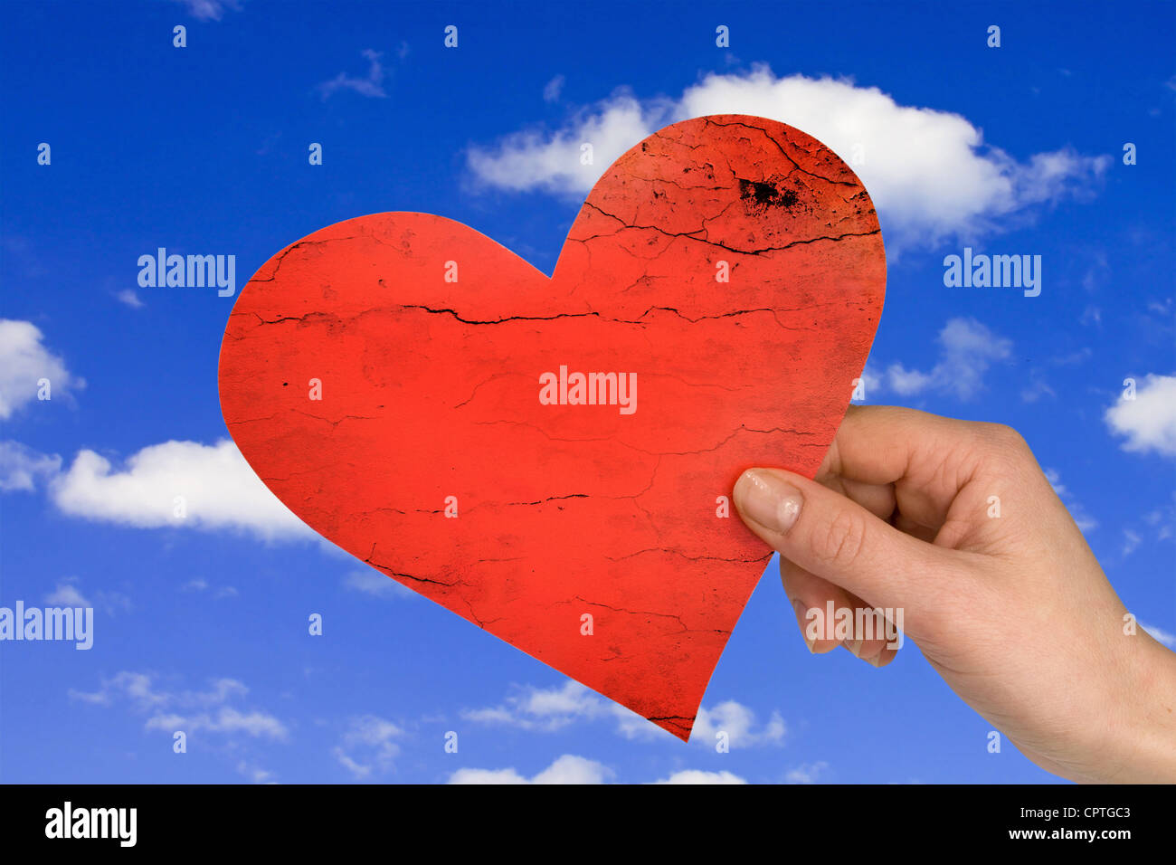 love concept. hand with heart on sky background Stock Photo - Alamy