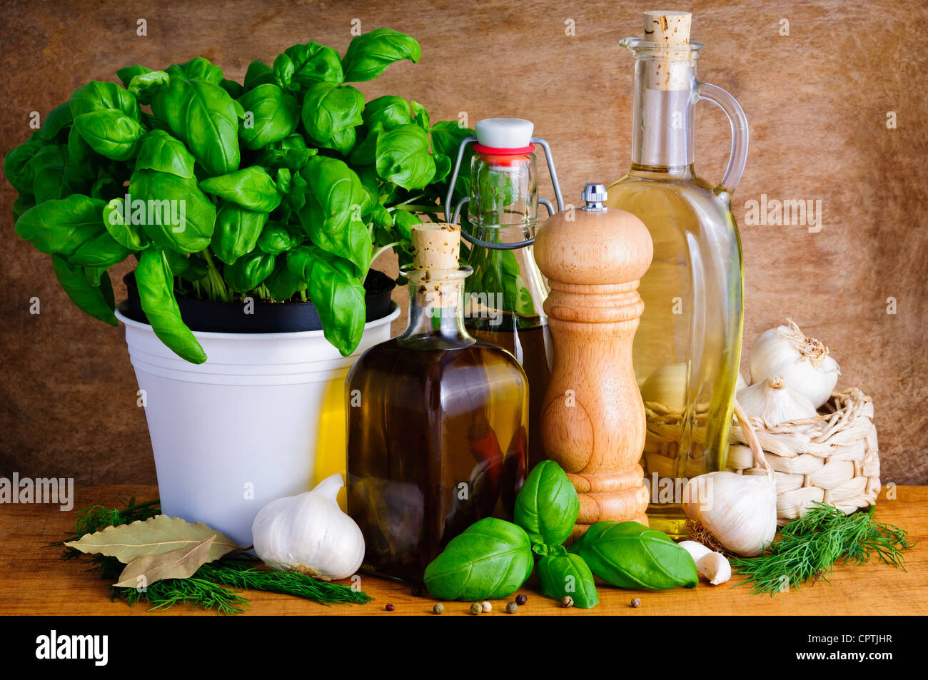 Still life with italian food seasoning, olive oil, herbs, garlic and pepper Stock Photo