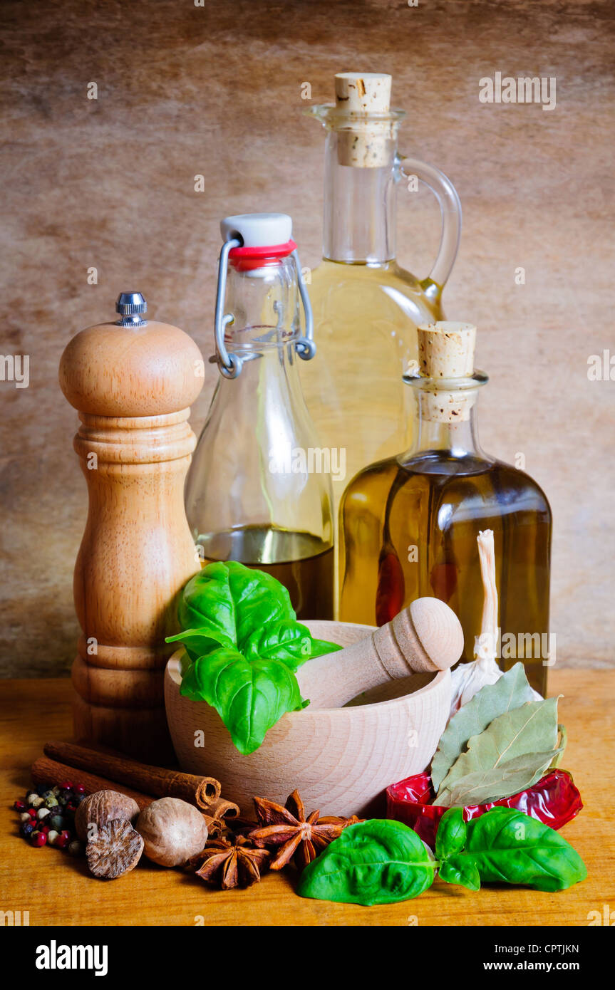 Still life with bottles of olive oil, herbs and spices Stock Photo