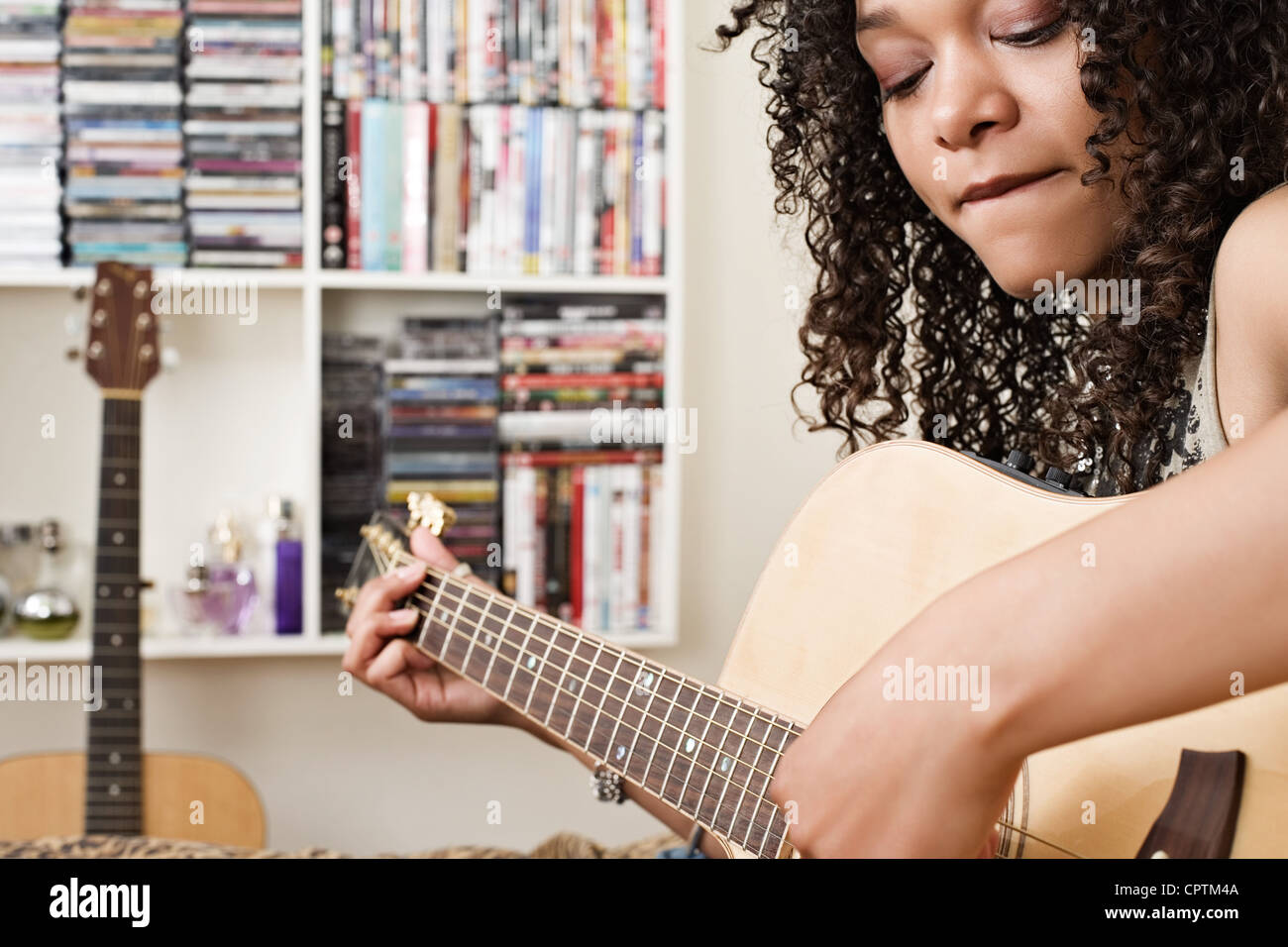 Young woman playing acoustic guitar Stock Photo - Alamy