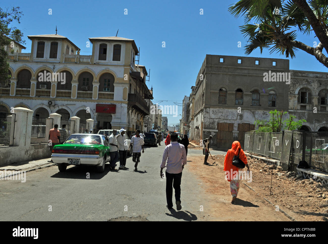 Local people walking down a road in a street scene in Djibouti City, east Africa. Stock Photo