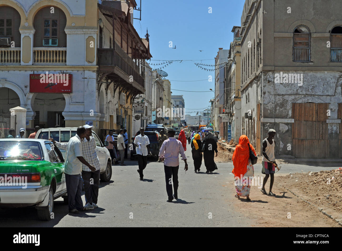 Local people walking down a road in a street scene in Djibouti City, east Africa. Stock Photo