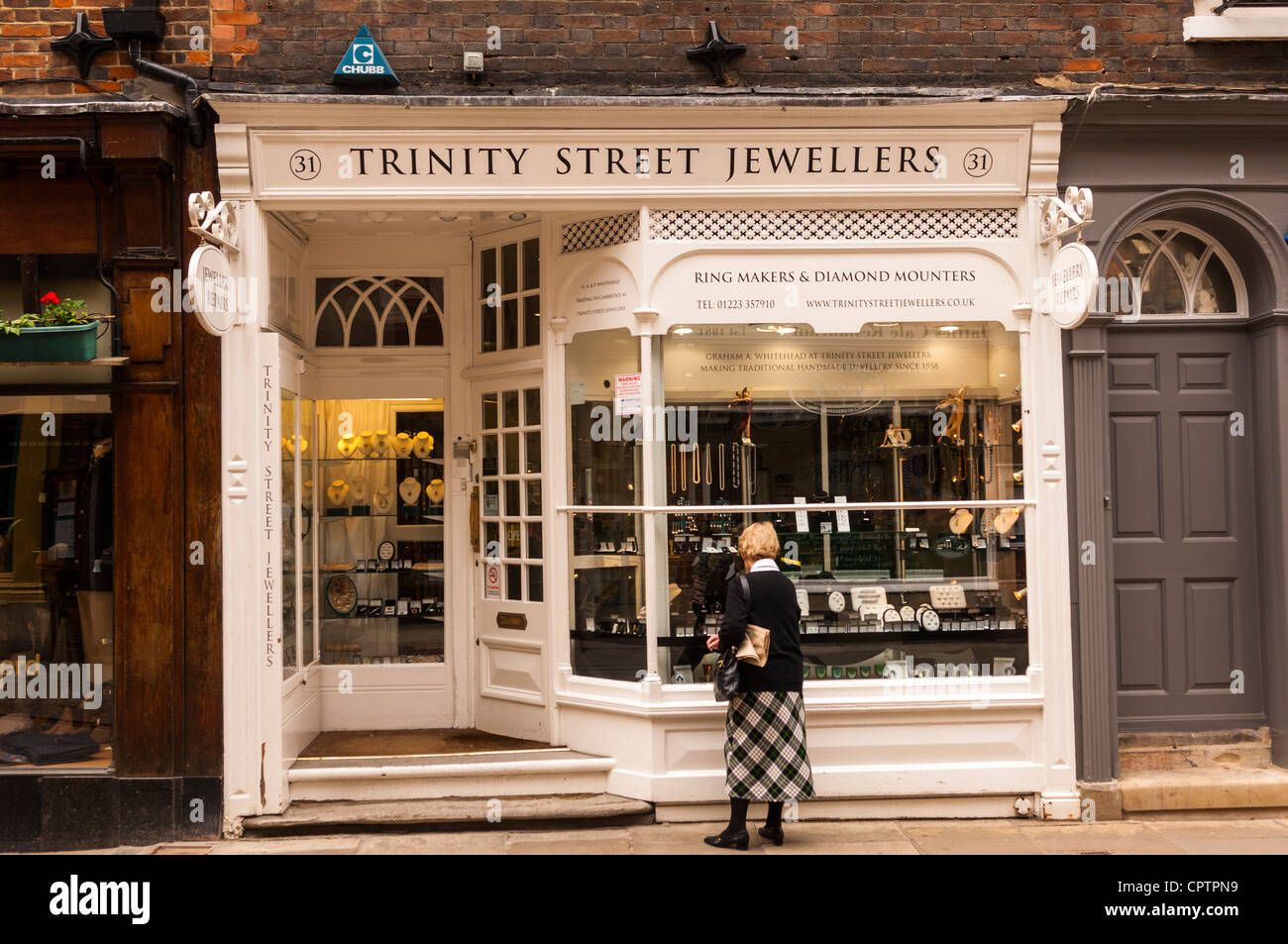 A woman window shopping in Trinity Street Jewellers in Cambridge , England , Britain , Uk Stock Photo