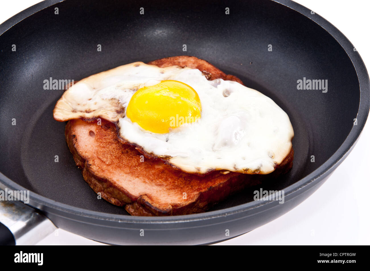 Fried egg in a skillet isolated on white background Stock Photo - Alamy