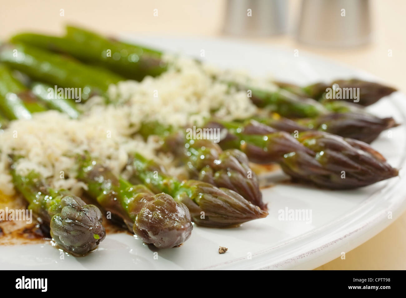 A really delicious combination, fresh steamed asparagus with parmesan and balsamic vinaigrette. Stock Photo
