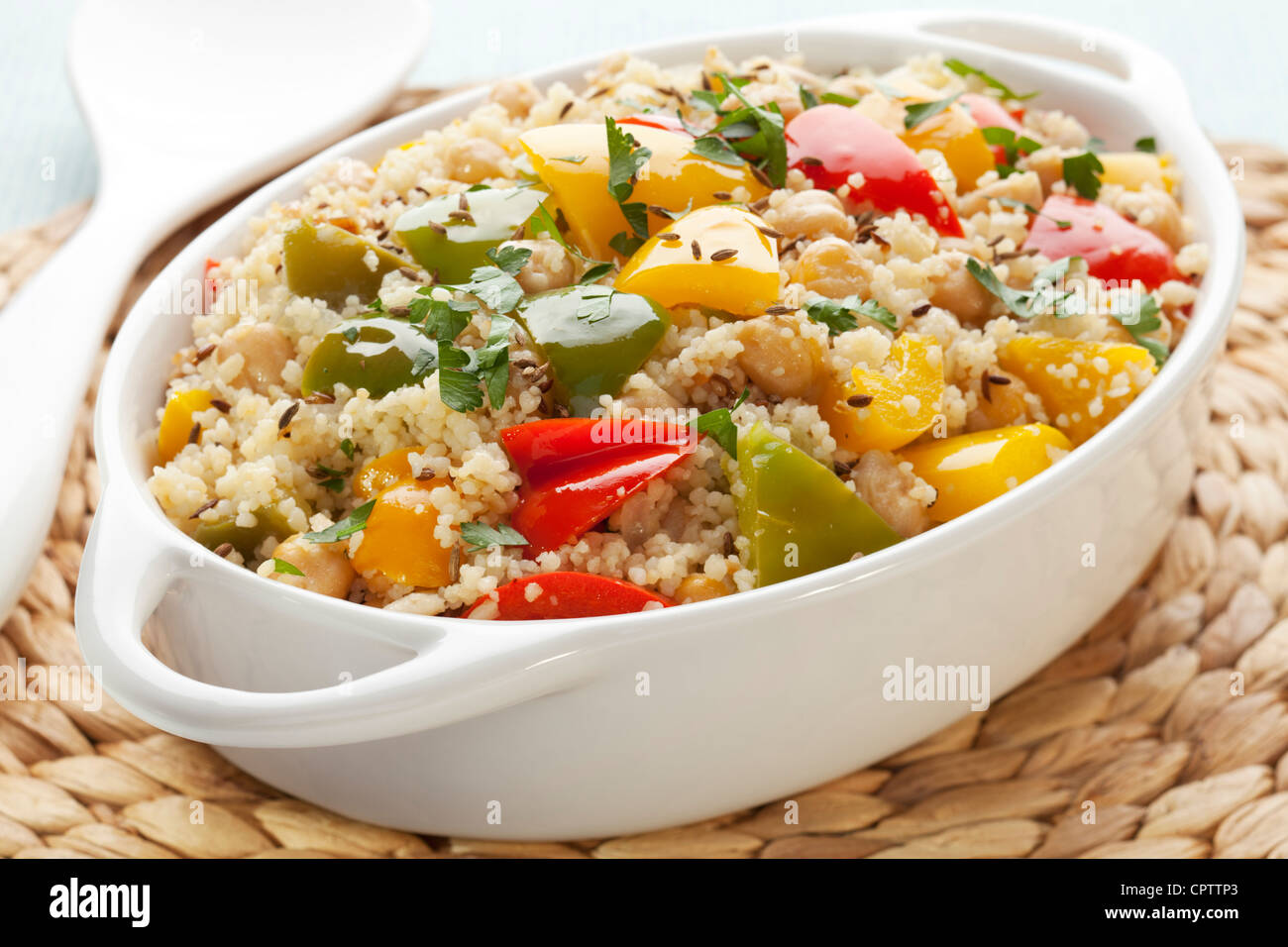 Couscous with chickpeas, red, green and yellow peppers, onion, cumin