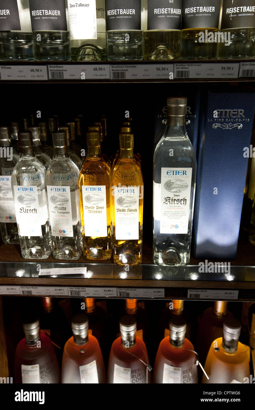 Liquor, pear liqueurs and raspberry liqueur on display at Dalmayr food shop and delicatessen in Munich, Bavaria, Germany Stock Photo