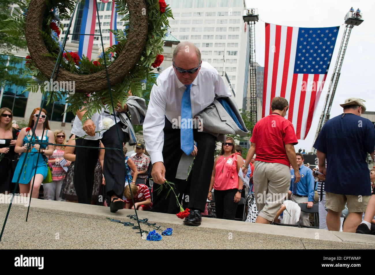 Hoosiers drop flowers at the base of a red, white and blue wreath to ...