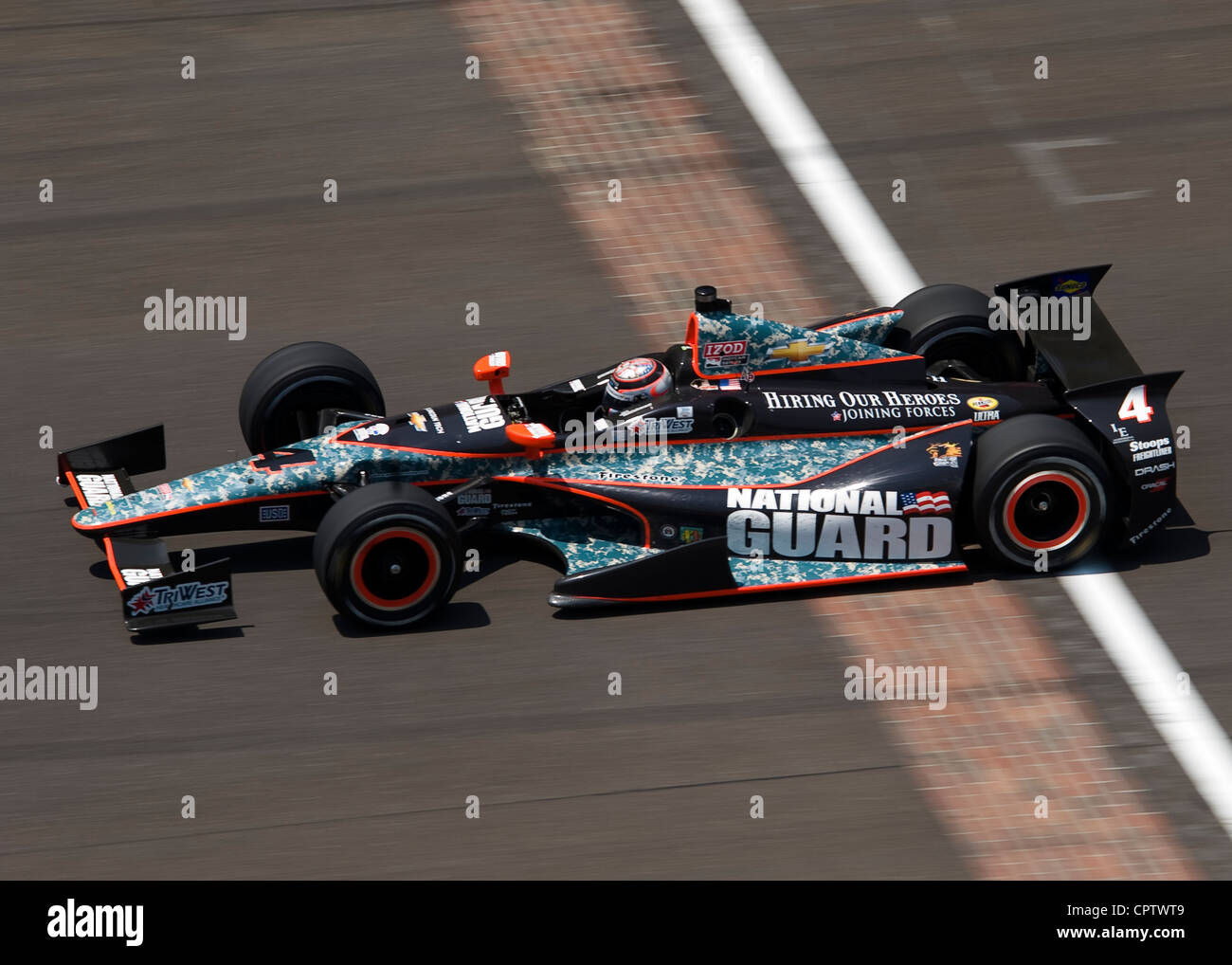 National Guard Sponsored #4 IndyCar machine Panther Racing Driver JR Hildebrand speeds past the “Yard of Bricks” finish line at Indianapolis Motor Speedway finishing in 14th place at the 96th running of the Indy 500, Sunday, May 27, 2012. Stock Photo