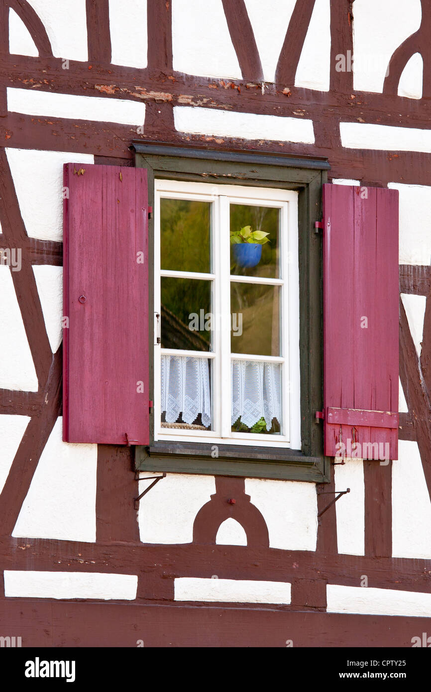 Windows and wooden shutters of quaint timberframed house in Schiltach