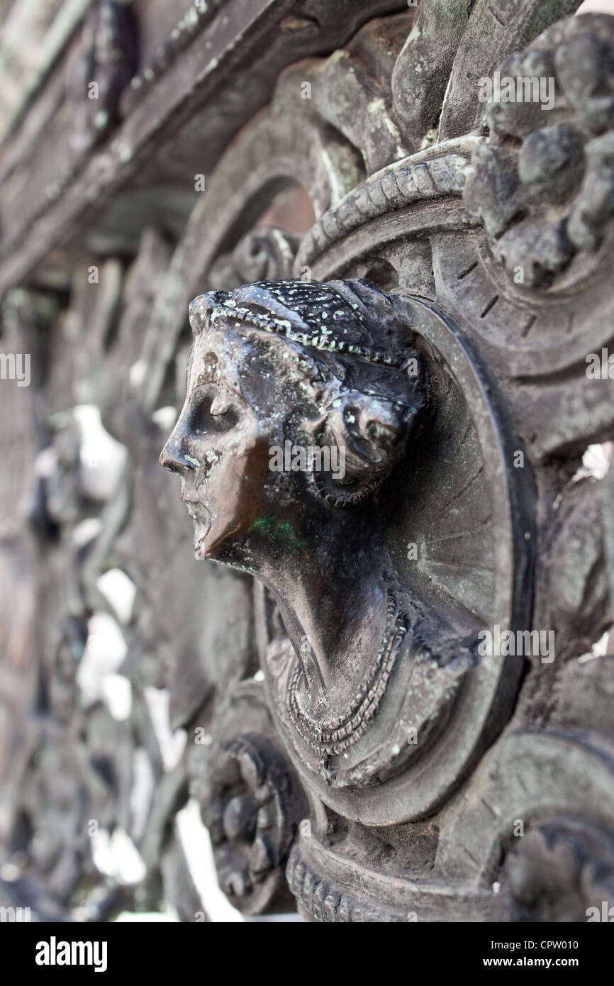 bust of a woman in bronze as a detail of fencing of Colleoni chapel in Bergamo Stock Photo