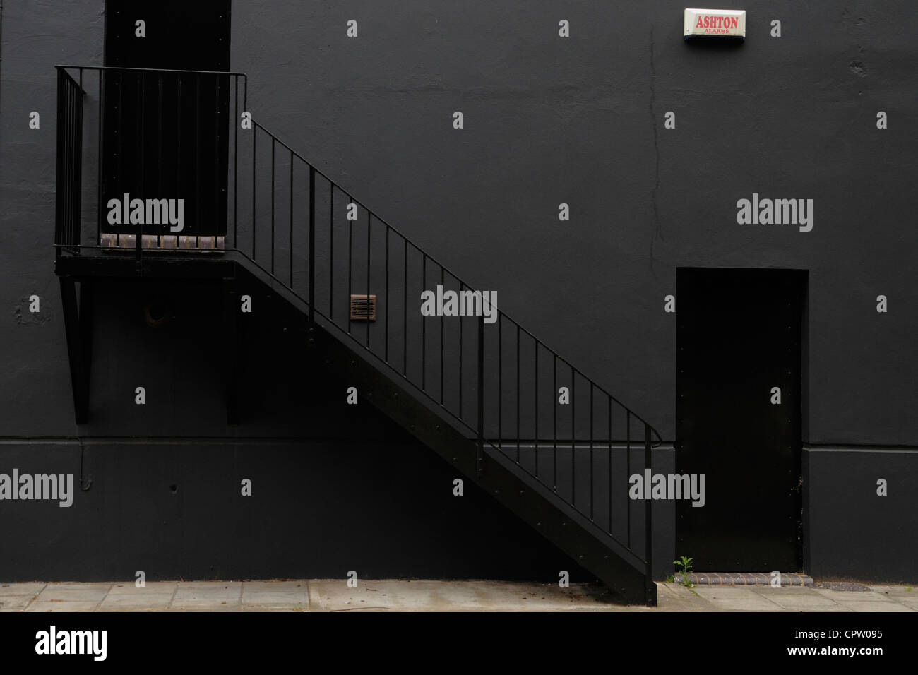 Black wall, doors and metal stairs, London. Stock Photo