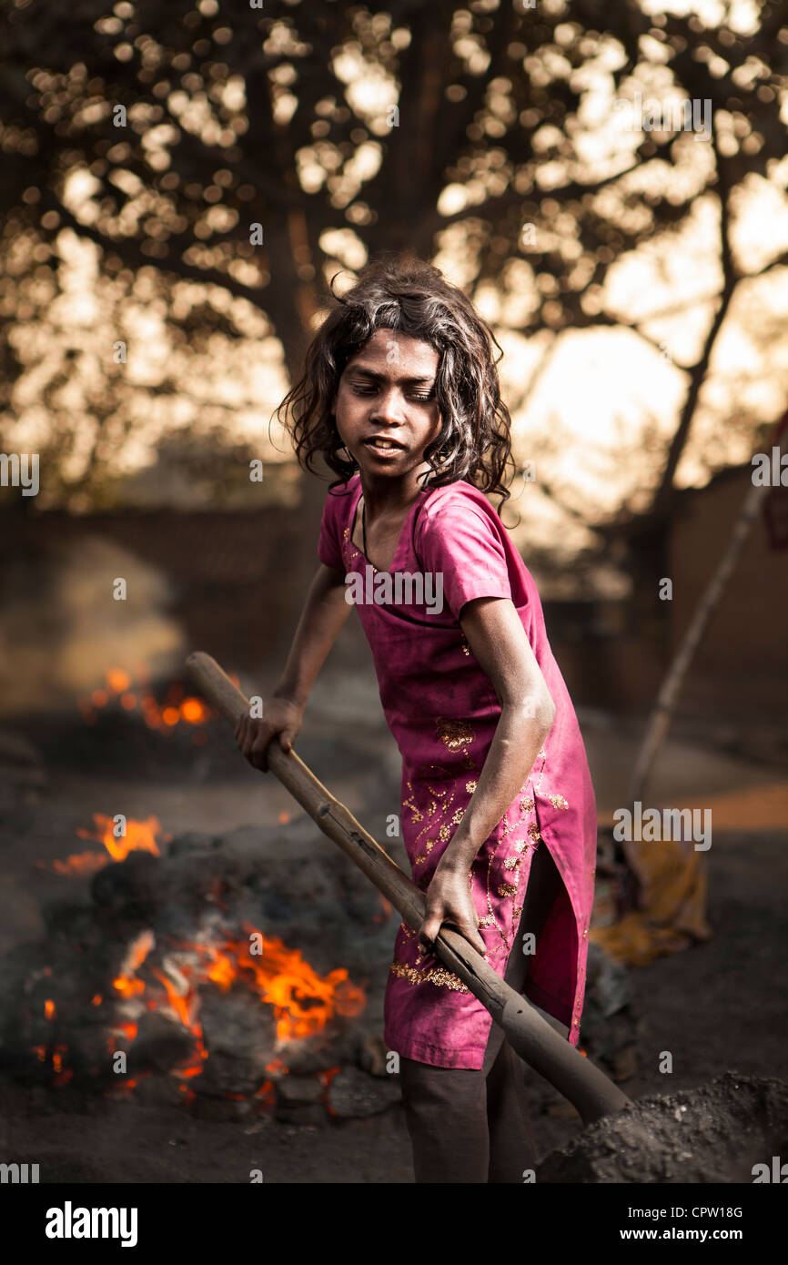 Little girl help the family work control the preburn bituminous coal