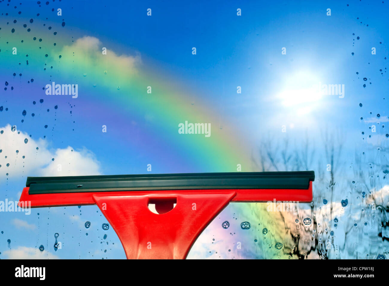 Concept of cleaning window against blue sky and rainbow Stock Photo