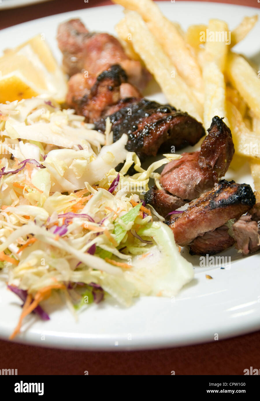 pork and liver kabob shish kabab meal salad French fried potatoes as